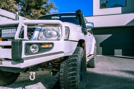 White four wheel drive truck parked in residential drivewayの写真素材