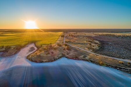 Sunset over fields and lake in Australiaの写真素材