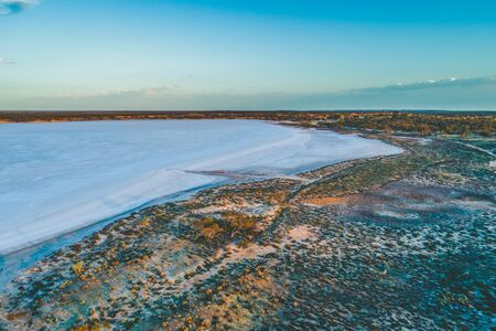 Salt lake in Australian desert at dawn - aerial viewの写真素材