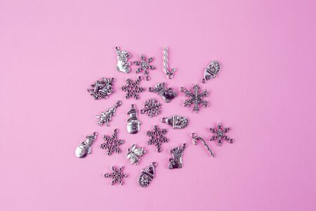 Silver Christmas decorations on pink background - top view with copy spaceの写真素材