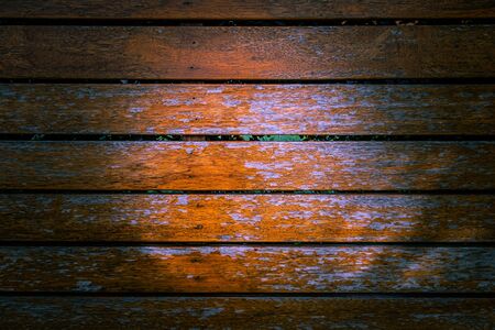 Wooden planks with peeling orange paint background textureの写真素材