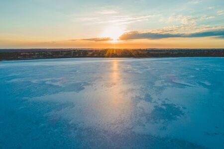 Sunrise shining on beautiful salt textures on lake surface in Australian Desertの写真素材