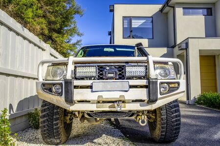 4WD truck with bull bar parked in a driveway front viewの写真素材