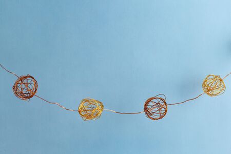 Copper new year garland on light blue background with copy spaceの写真素材