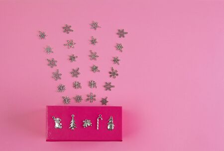 Rays of snowflakes coming out of pink box with copy space - holidays conceptの写真素材