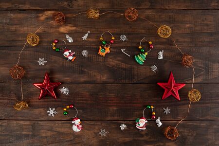Christmas decorations arranged on wooden background - top view with copy spaceの写真素材