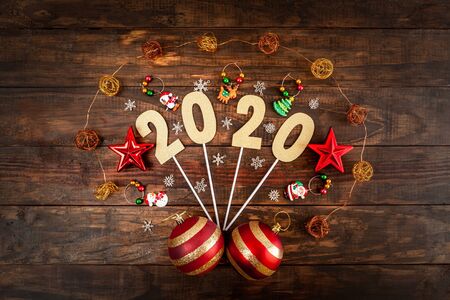 Happy new year 2020 concept with Christmas decorations on wooden backdrop - top viewの写真素材
