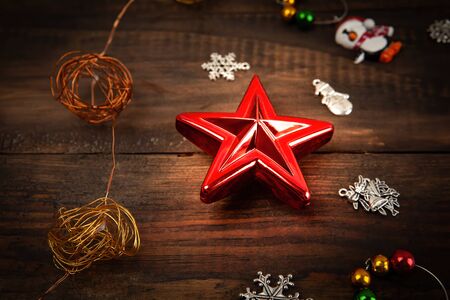 Christmas decoration red glowing star on wooden table extreme closeupの写真素材