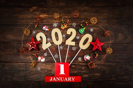 January 1st 2020 - happy new year greetings concept flatlay with Christmas decorations and numbers on wooden backdrop - top viewの写真素材