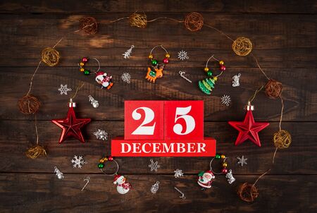 December 25th - Christmas Day concept depicted with the date and decorations arranged on rustic wood - top viewの写真素材