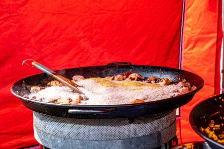 Large frying pan with rice and chicken meat - street food with copy spaceの写真素材