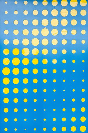 Abstract pattern of yellow circles in various sizes on blue backgroundの写真素材