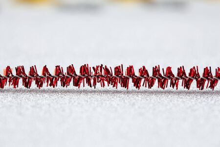 Extreme closeup of Christmas decoration on silver glittery background with copy space and shallow focusの写真素材