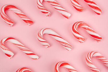 Closeup of candy canes on pink background - top viewの写真素材
