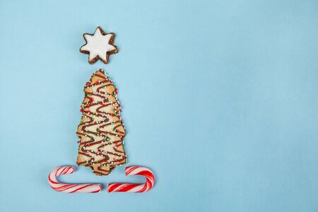 Christmas tree biscuit on blue background - top view with copy spaceの写真素材