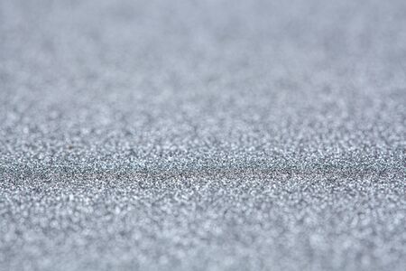 Silver glitter abstract background with shallow focus and copy spaceの写真素材