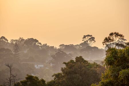 Rural homes in Victoria covered in smoke haze from bush firesの写真素材