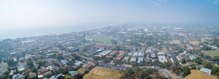 Heavy smoke haze covering suburbs in Victoria, Australia - aerial panorama of Frankston