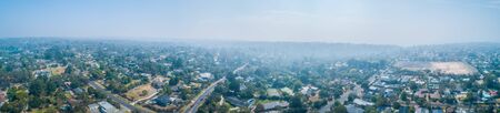 Bush fire smoke covers suburban areas in Melbourne - wide aerial panoramaの写真素材