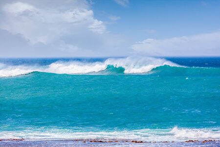 Beautiful turquoise crushing waves near ocean coast