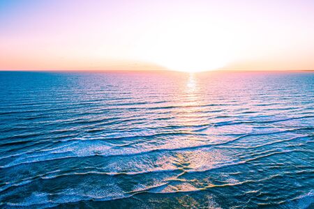 Bright sunset over sea - minimalist aerial seascapeの写真素材