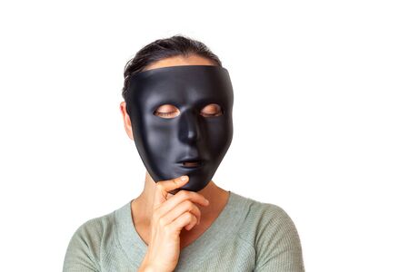 Caucasian woman with closed eyes wearing a black mask - isolated on white with copy spaceの写真素材