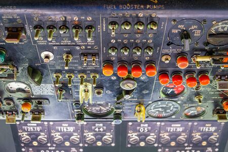 Extreme closeup of old aircraft cockpit control panels with switches and gaugesの写真素材