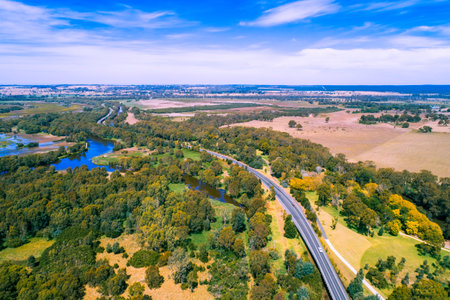 Rural highway passing through beautiful countryside in Victoria, Australiaの写真素材