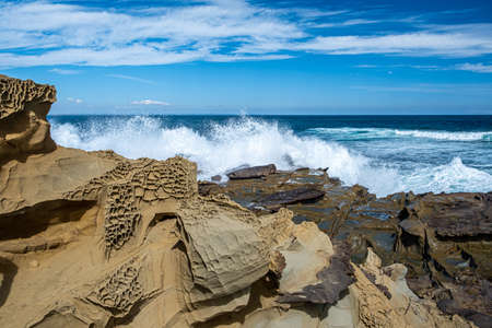 Powerful ocean waves crushing on sharp rocks - landscapeの写真素材