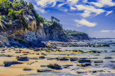 Amazing ocean coastline cliffs on beautiful summer day with white fluffy cloudsの写真素材
