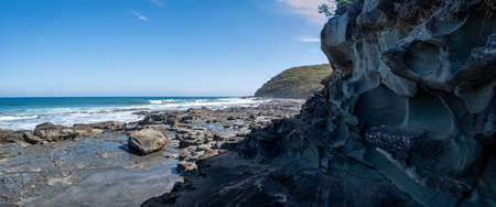 Scenic panorama of intricate rock formations on ocean coastline along the famous Great Ocean Walk in Australiaの写真素材