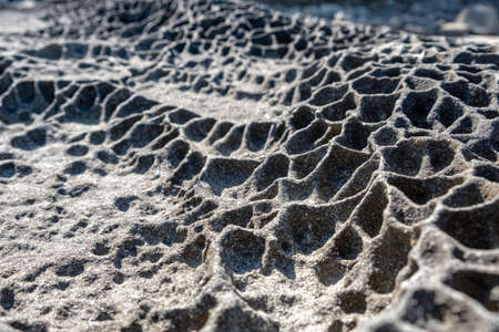 Eroded rock formations on ocean shore in the summer