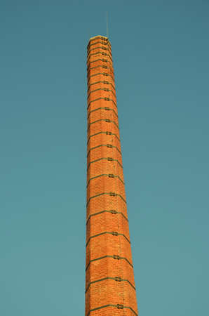 smokestack factories. Orange construction. blue sky. Harmful to the environment. tall chimneys.の写真素材