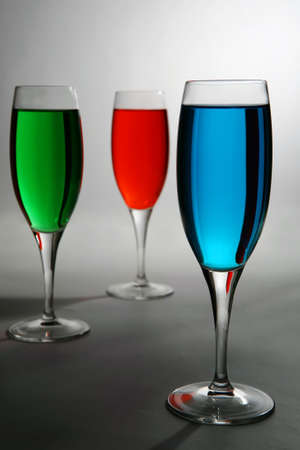 red green and blue colored cocktail over whiteの写真素材