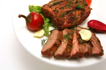 served roasted meat steak on color dishの写真素材