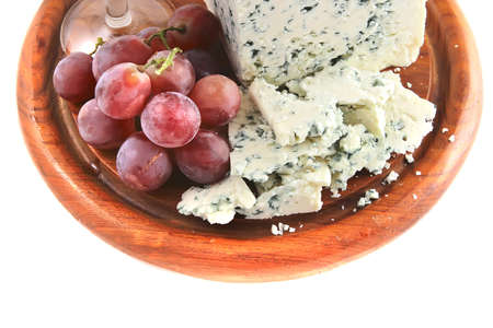 mold cheese and grapes on wooden plateの写真素材