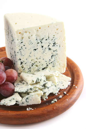 mold cheese and grapes on wooden plateの写真素材