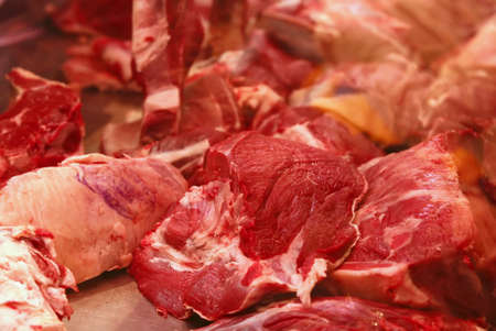 bloody meat chunks on market show windowの写真素材
