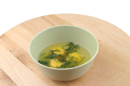 three raw broken eggs inside bowl on wood shelfの写真素材