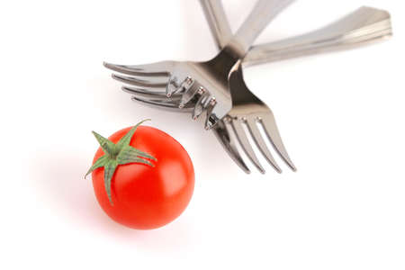 forks and tomato isolated over white backgroundの写真素材