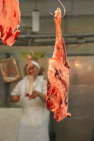 meat on hook on open market as backgroundの写真素材