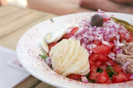 greece salad served on big white dishの写真素材