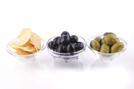 black and gold olives with chips over whiteの写真素材