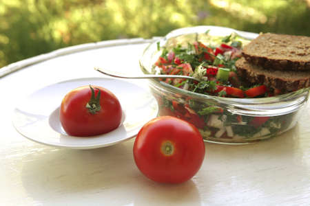 french bread and raw tomato on white tableの写真素材
