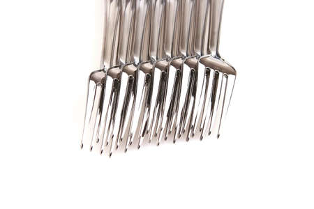 forks and tomato isolated over white backgroundの写真素材