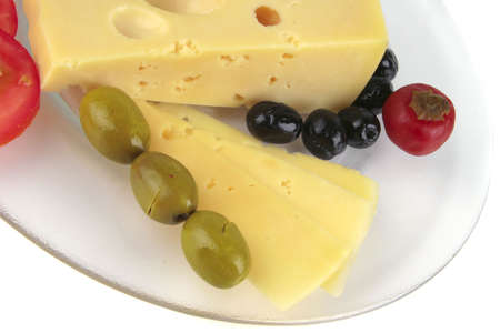 yellow cheese and vegetables on transparent dishの写真素材