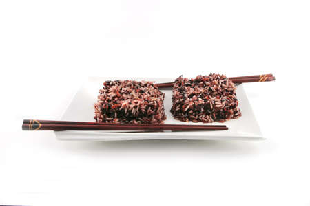 boiled dark mixed rice on white plateの写真素材