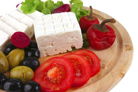 goat cheese served with vegetables on wooden plateの写真素材