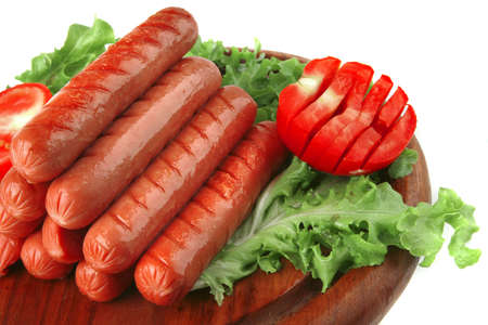 grilled sausages served on wooden plate over whiteの写真素材
