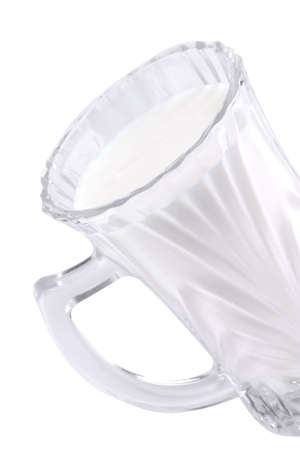milk in transparent glass over white backgroundの写真素材